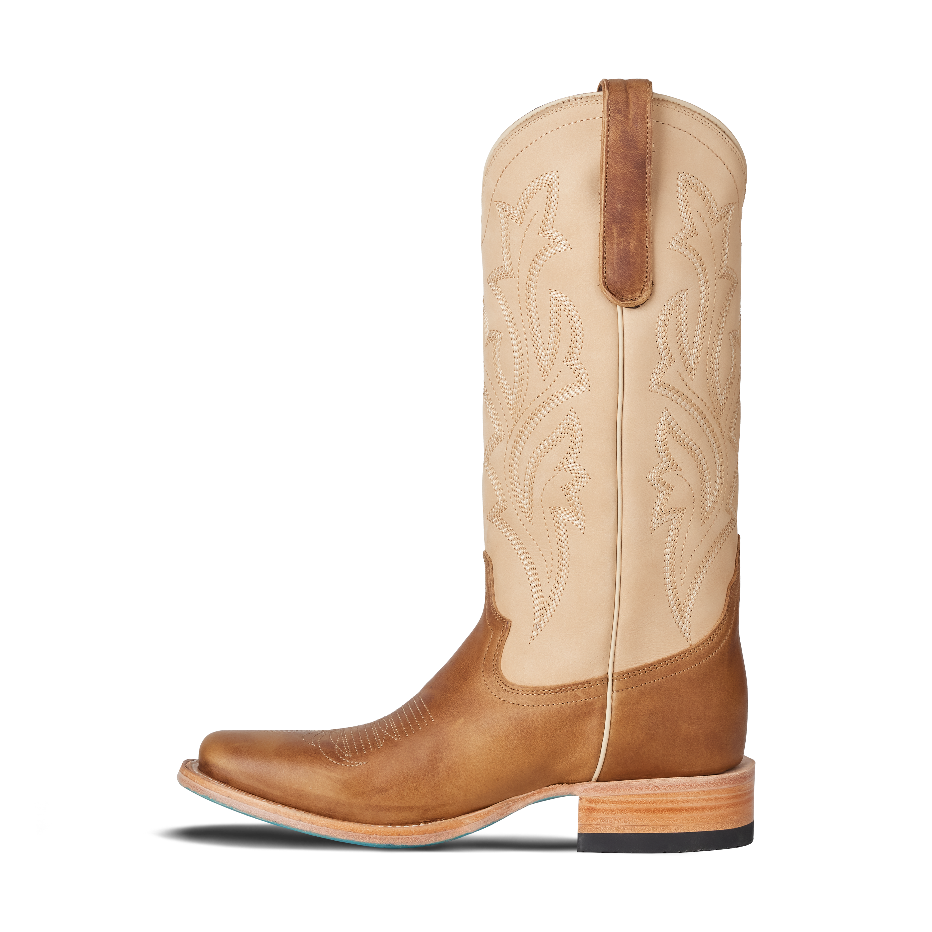Tan and beige cowboy boot on a white background