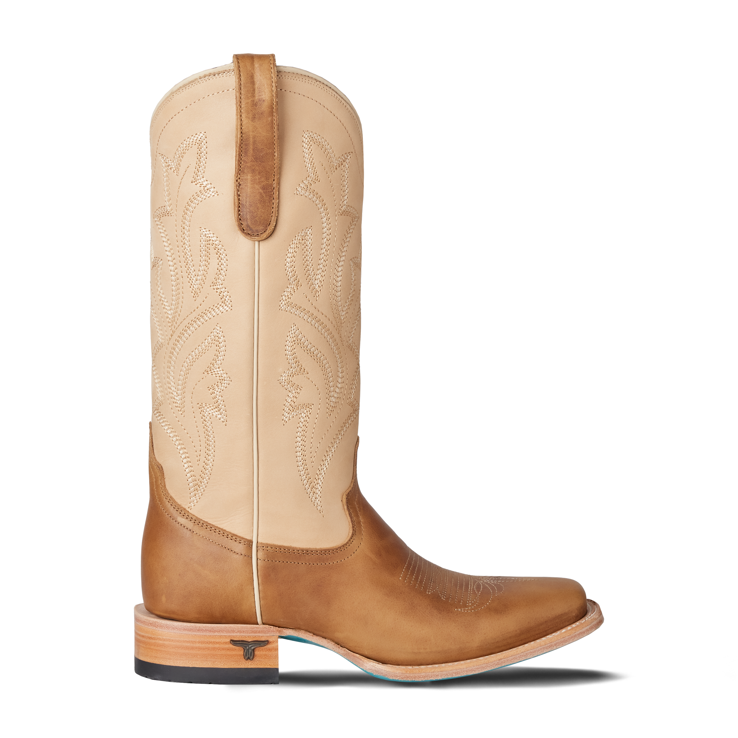 Tan cowboy boot with detailed stitching on a white background
