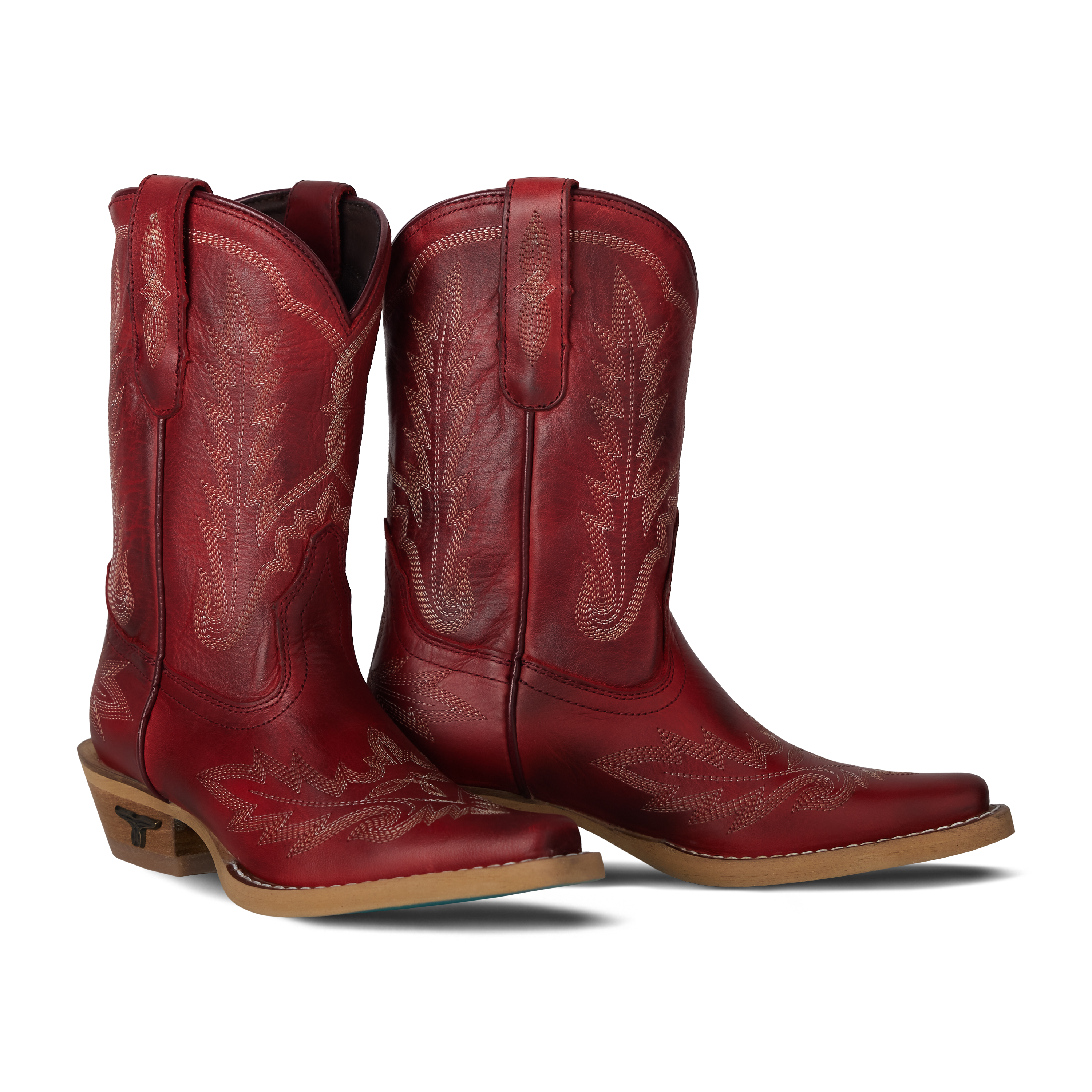 Pair of red cowboy boots on a white background